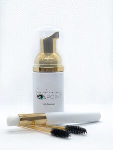 Lashes On Point lash shampoo bottle and cleansing brush from the complimentary aftercare kit
