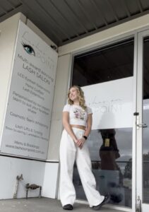 Nina Andrews standing outside Lashes On Point salon in Mill Park, Melbourne, showcasing the multi-award-winning lash studio.