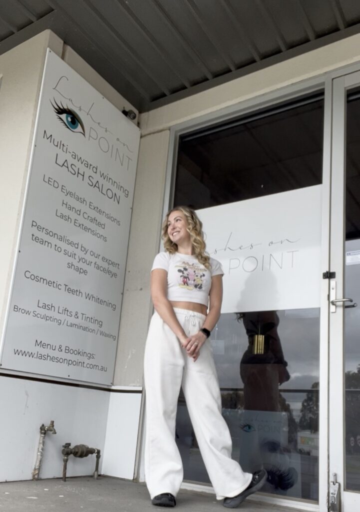 Nina Andrews standing outside Lashes On Point salon in Mill Park, Melbourne, showcasing the multi-award-winning lash studio.